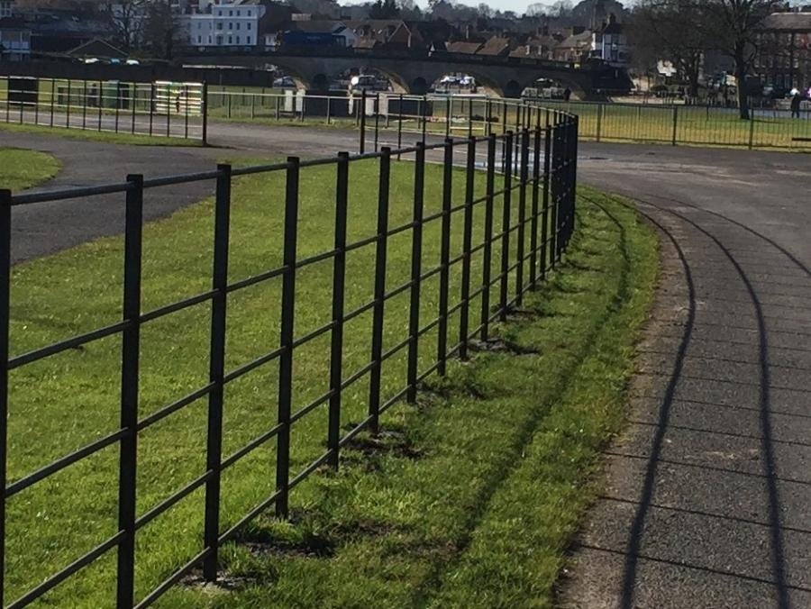 Black metal fencing alongside the roadway at Henley